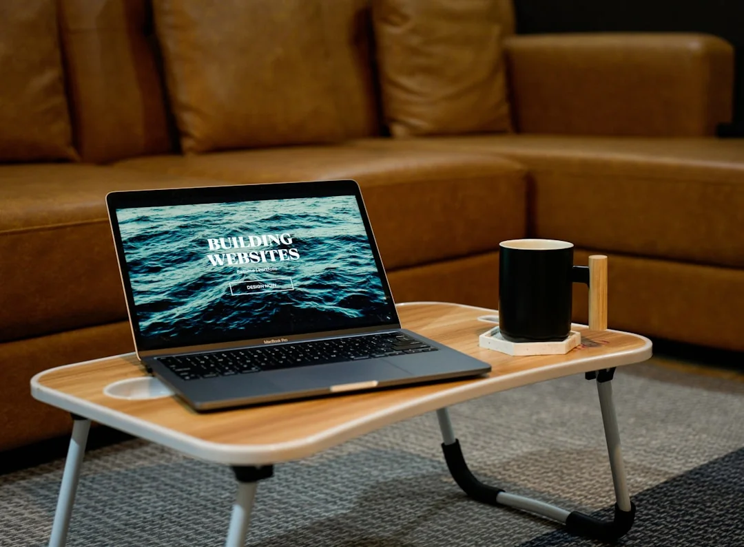 A sleek office desk setup featuring Apple devices: iMac, MacBook, and iPad.